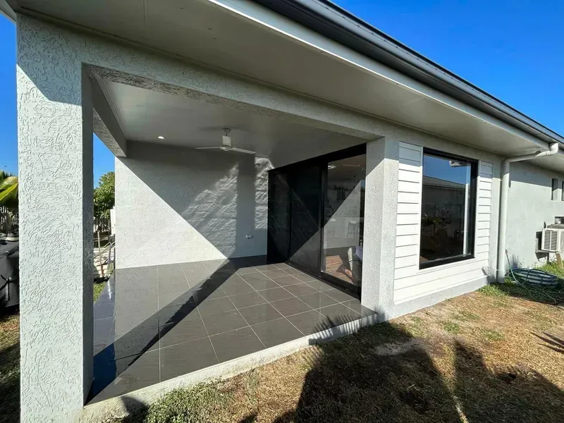A White House With a Covered Porch and a Sliding Glass Door — Ironbark Built Townsville in Currajong, QLD