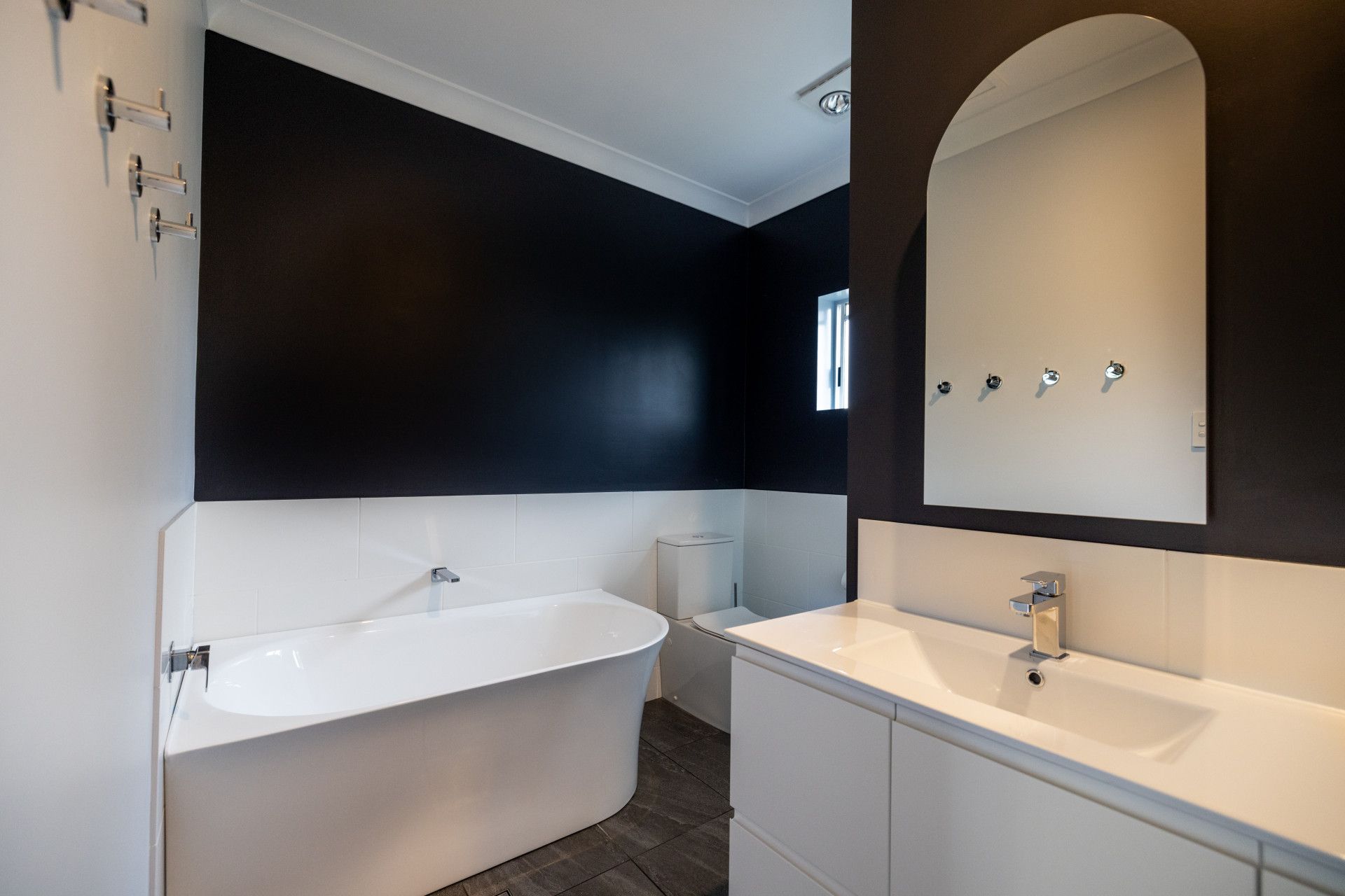 Bathroom With a Bathtub and a Painting on the Wall — Ironbark Built Townsville in Currajong, QLD