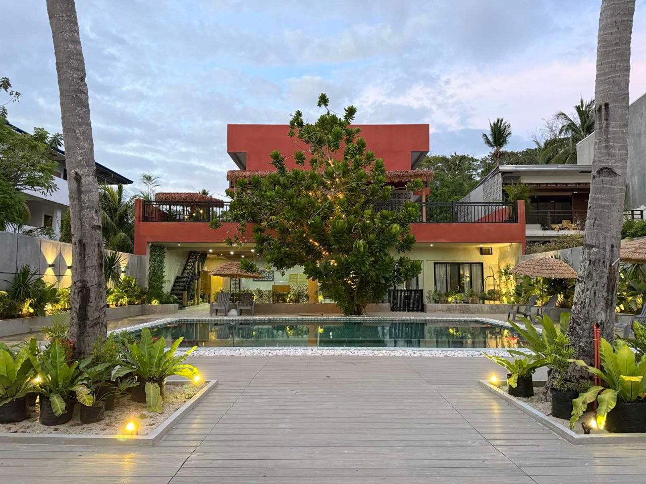 A large house with a swimming pool in front of it.