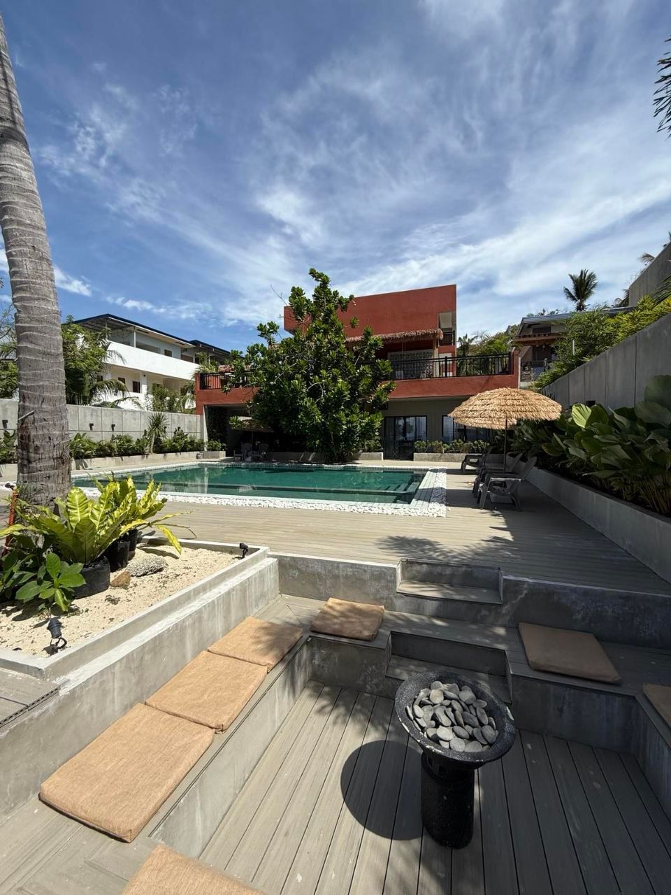 A large house with a swimming pool in front of it