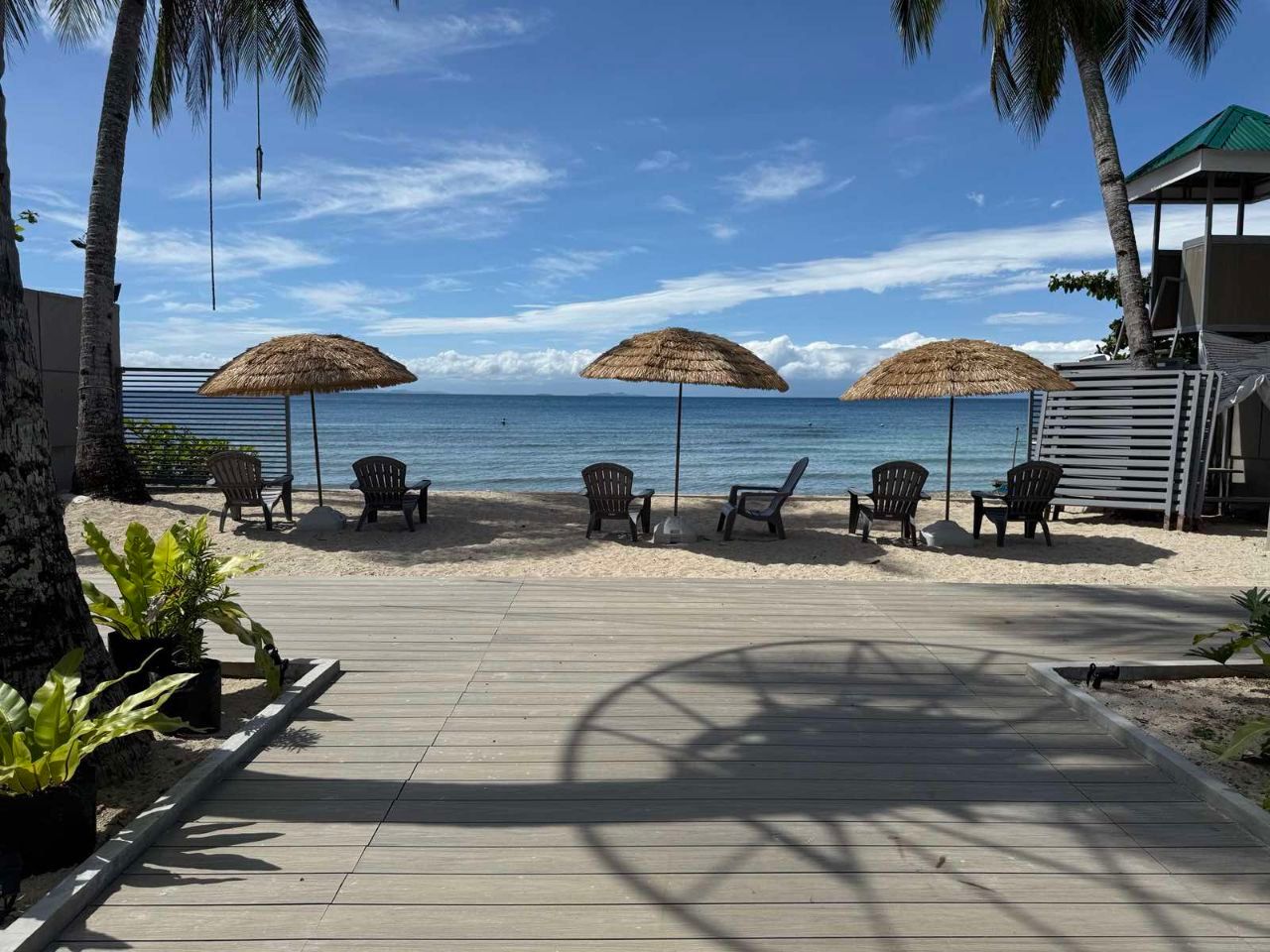 A beach with chairs and umbrellas on a sunny day