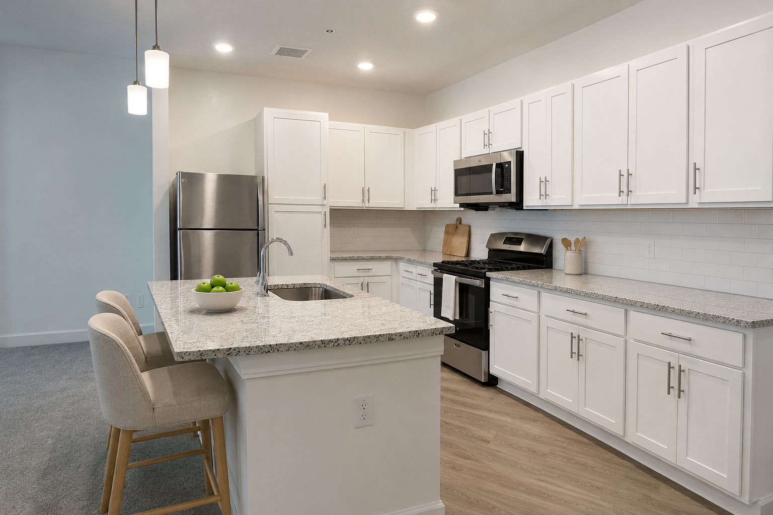 Bright modern kitchen with white cabinets, stainless steel appliances, and a central island with two stools