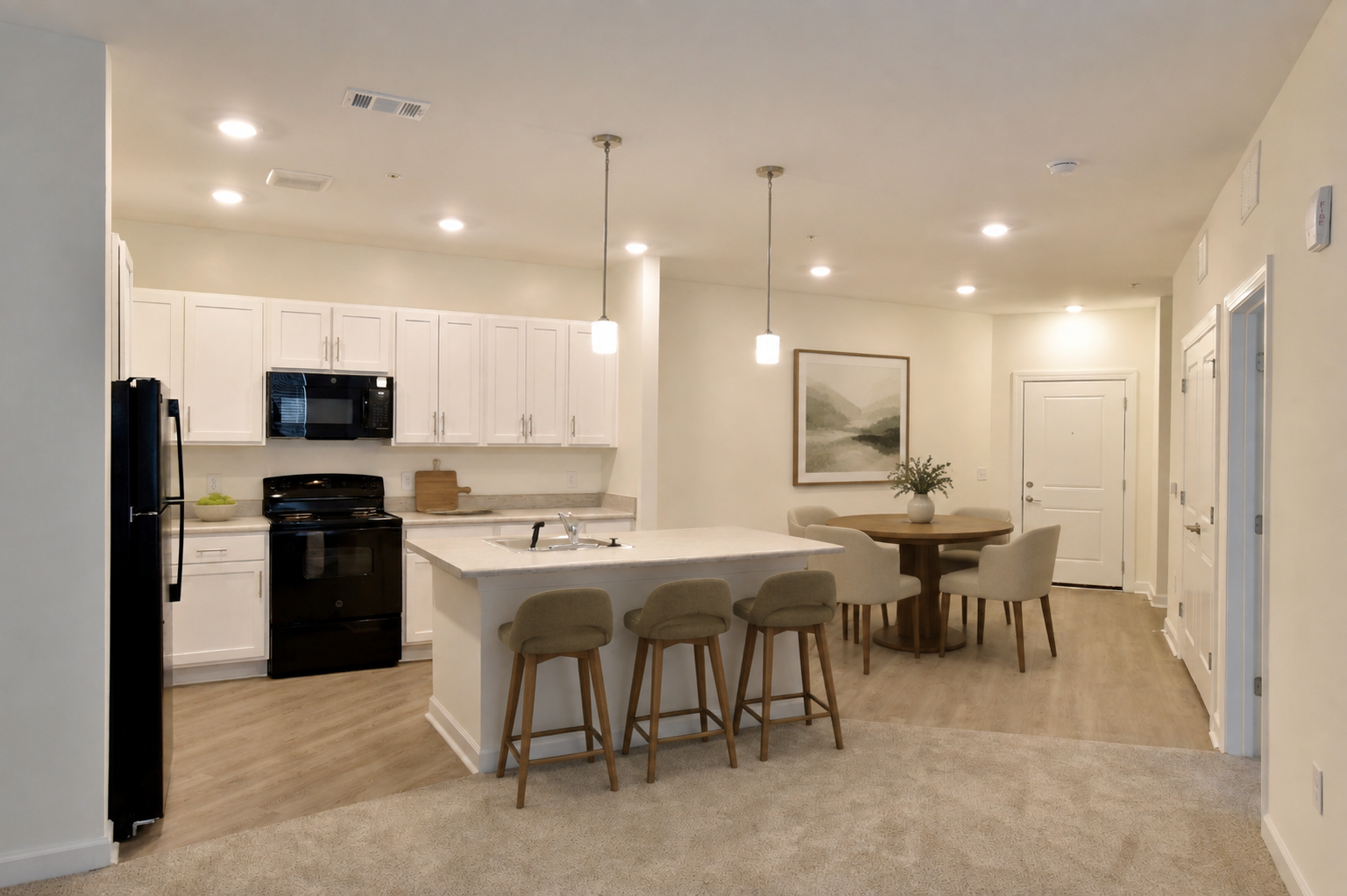 Spacious apartment community lounge with seating areas, tables, and a stone fireplace.