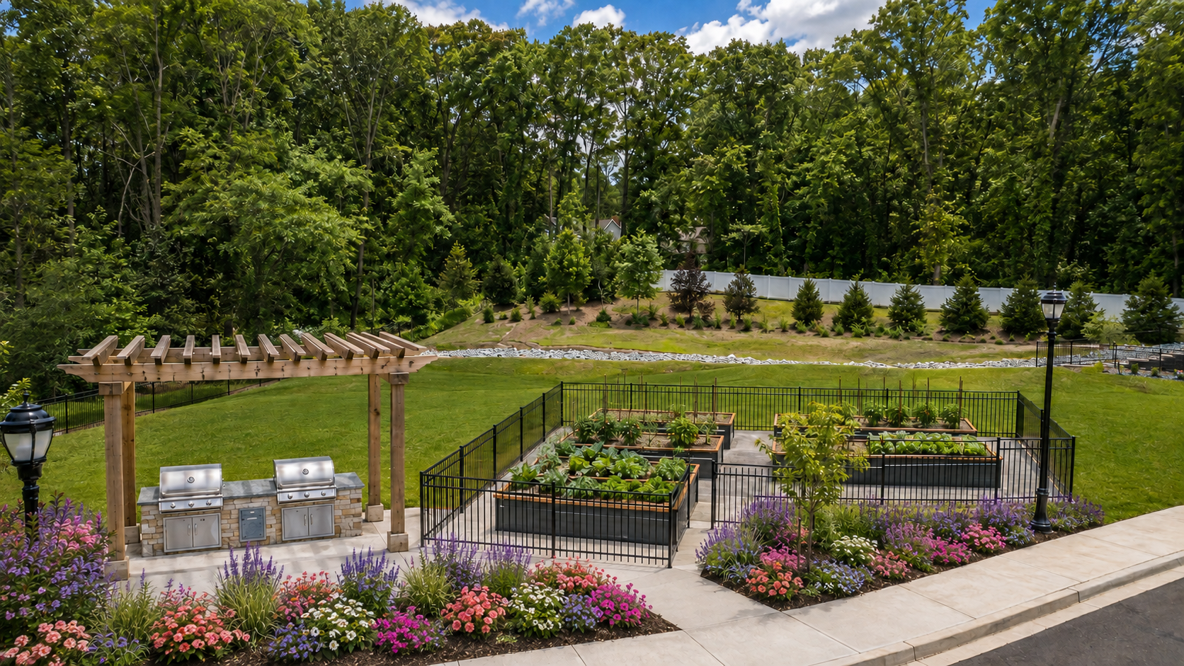 Raised flower beds in a landscaped garden with colorful blooms, gravel paths, and trees beyond.
