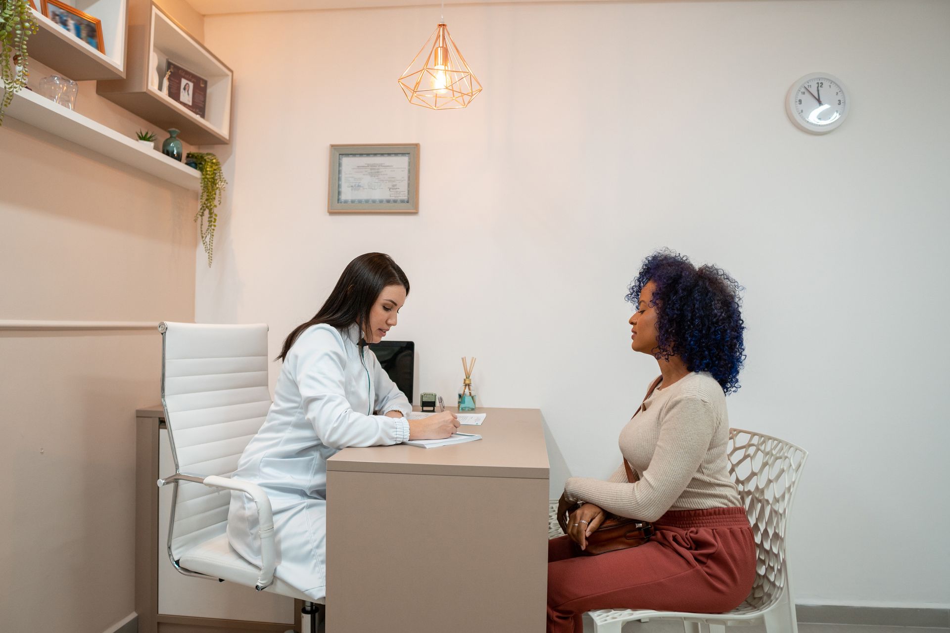 Woman Is Sitting At Table - San Antonio, TX - La Femme OB/GYN