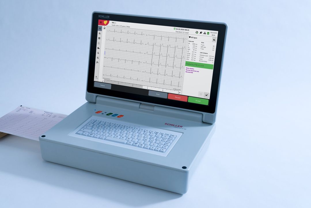 A laptop computer with a keyboard is sitting on a table.