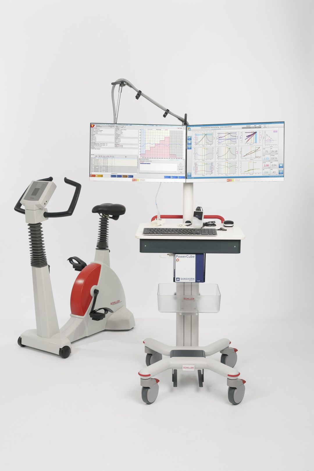 A bicycle is sitting next to a computer on a cart.