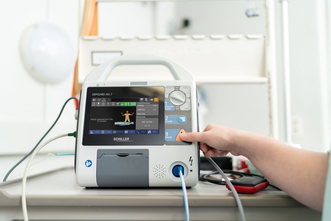 A person is pressing a button on a medical device.