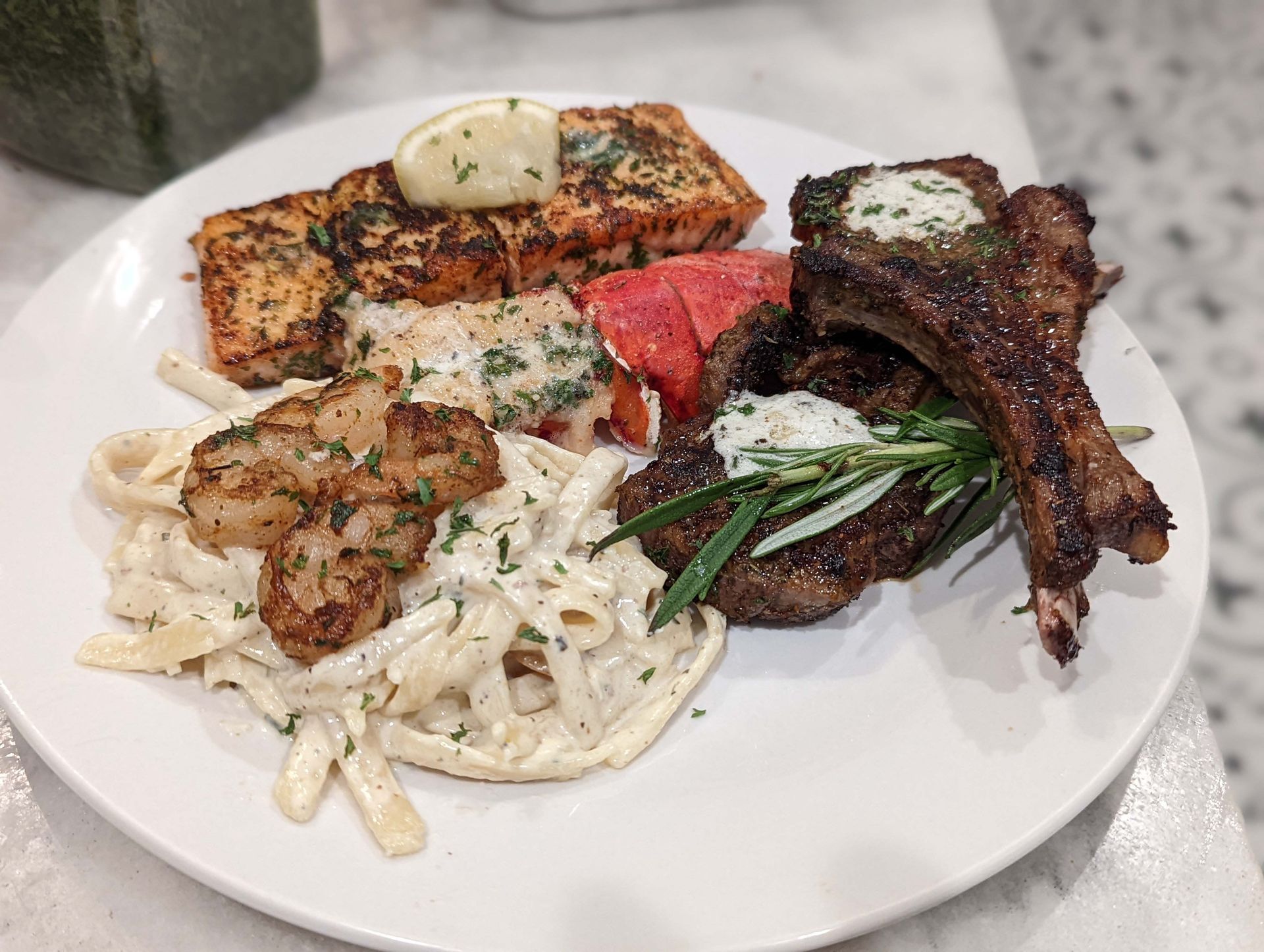 A white plate topped with a variety of food on a table.
