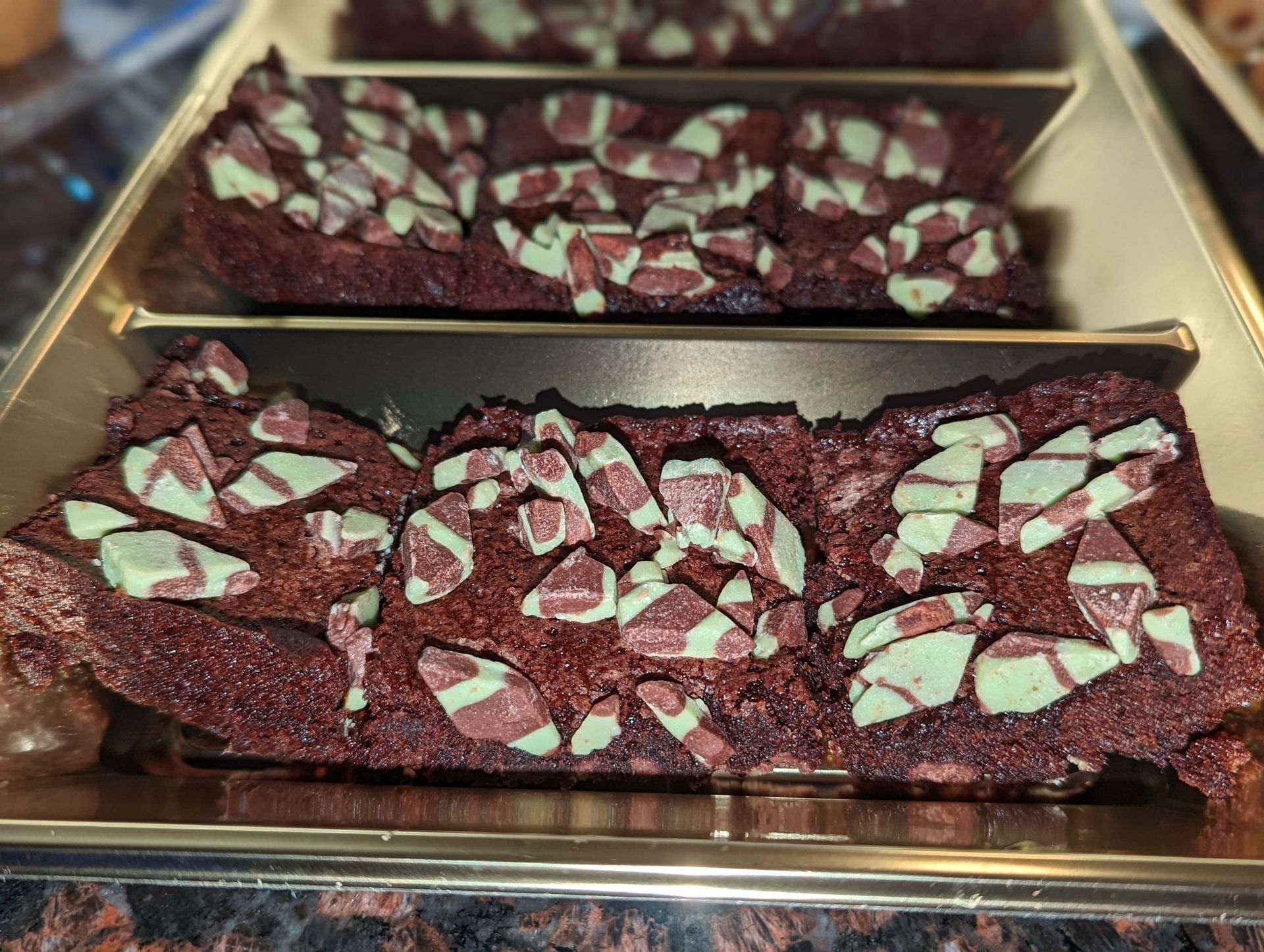 A box of brownies with mint candy canes on top