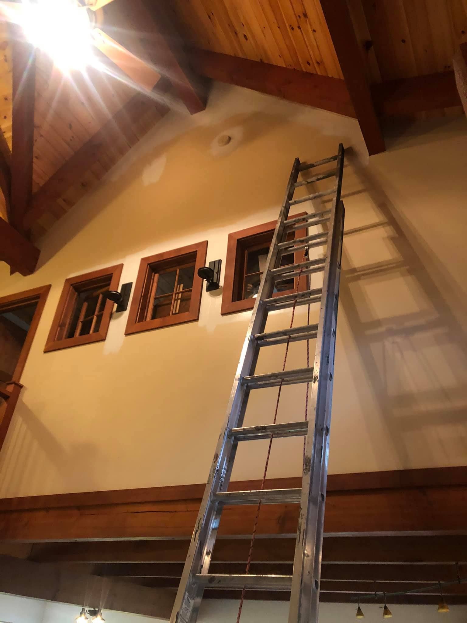 A ladder is hanging from the ceiling of a house