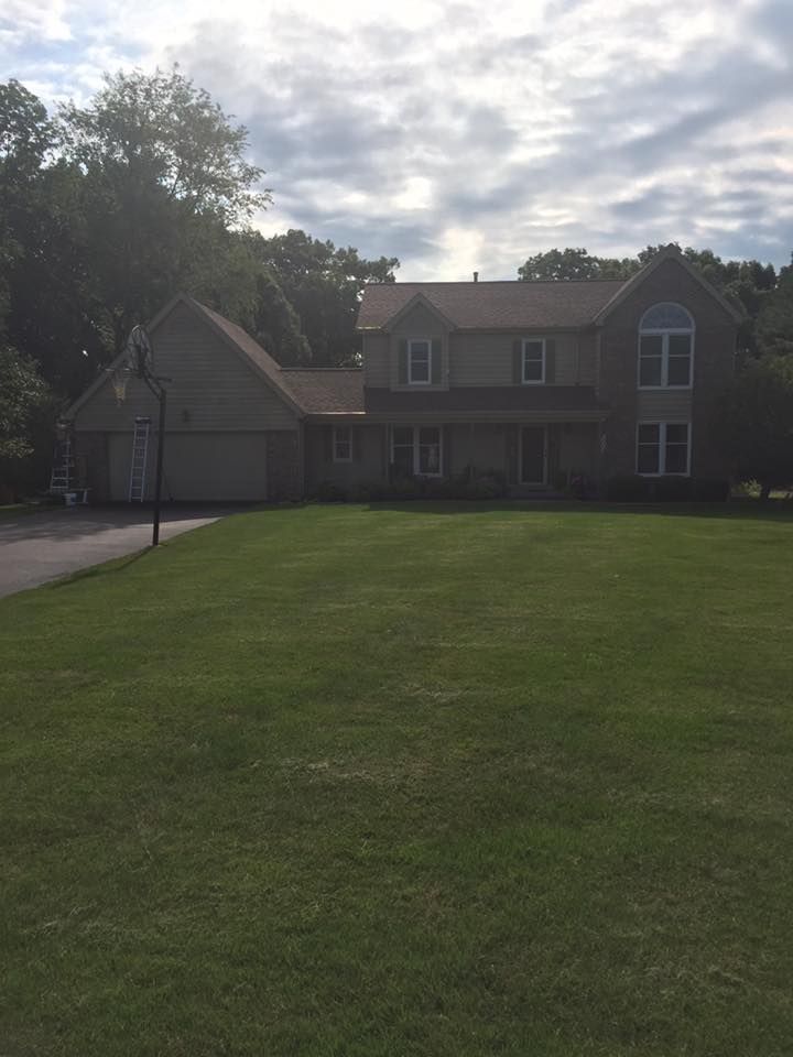 A Large House With A Large Lawn In Front Of It