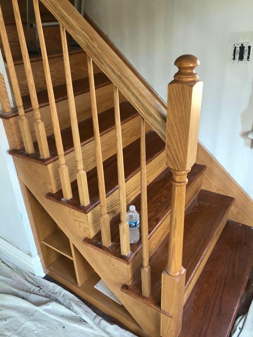A wooden staircase with a bottle of water on the steps.