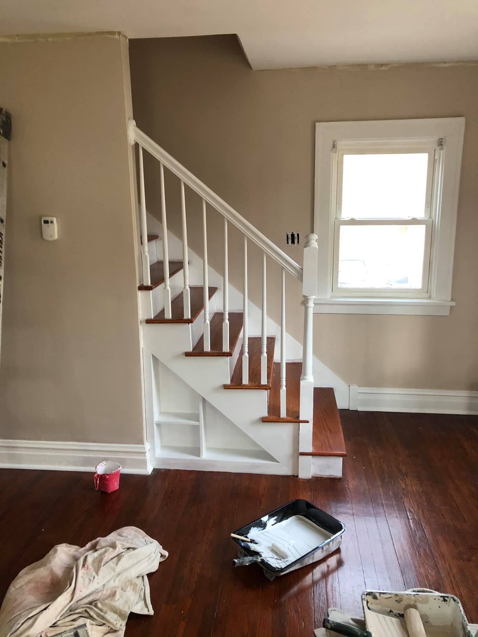 A living room with a staircase and a window