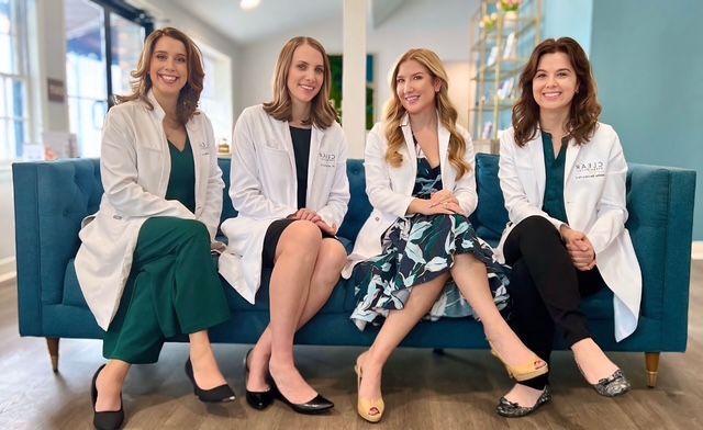 staff in office wearing white lab coats