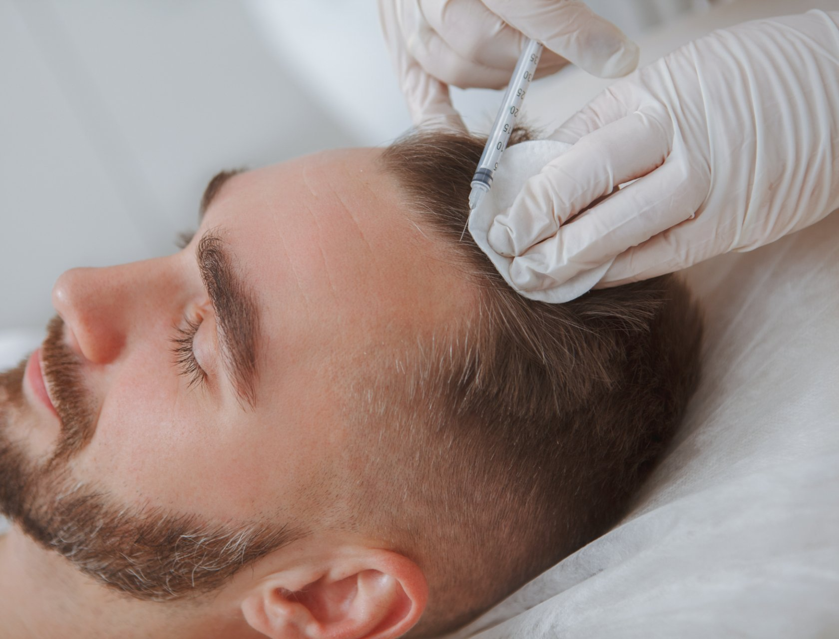 young female dermatology patient receives frown lines injection in forehead