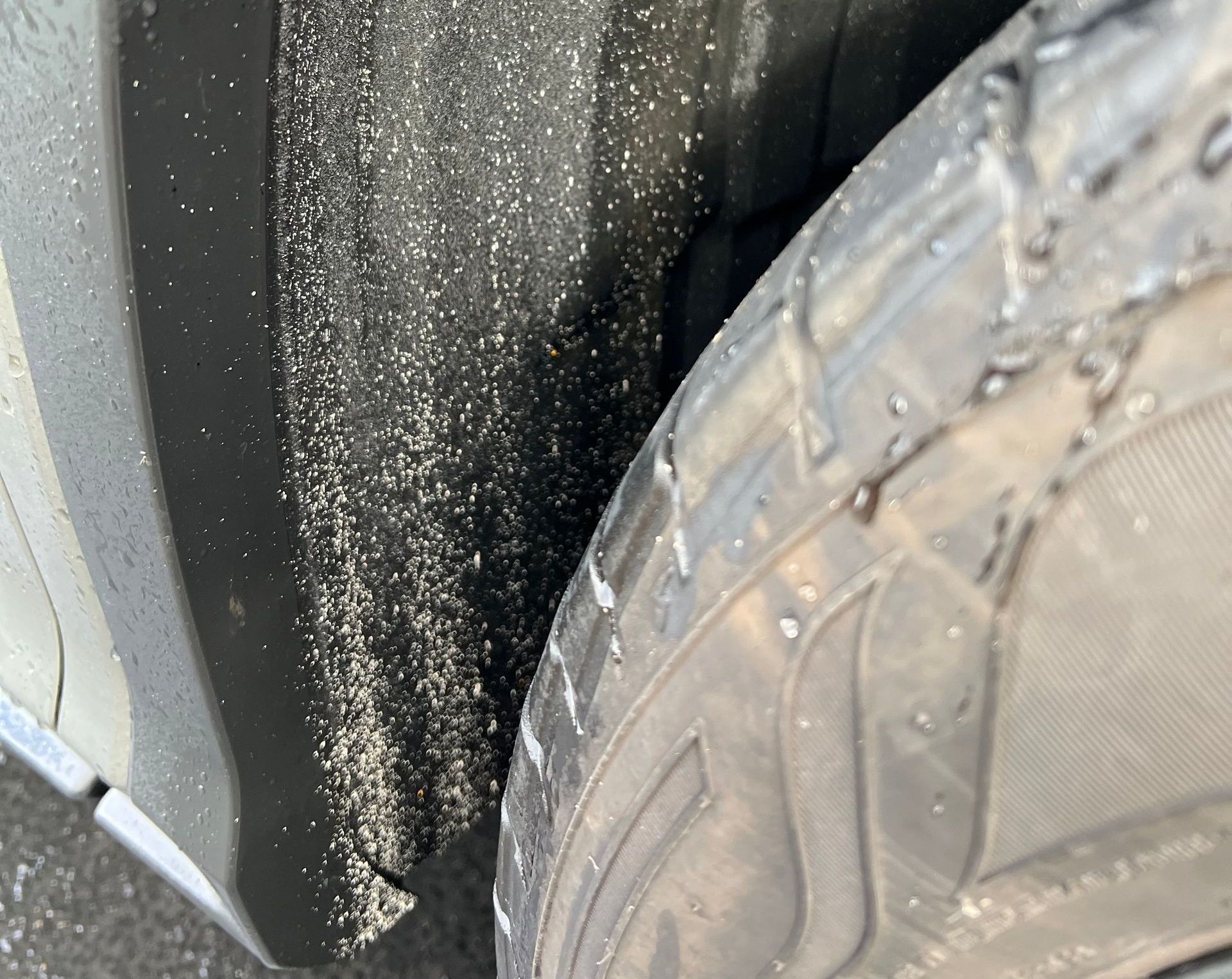 A black toyota tacoma truck is parked in a driveway.
