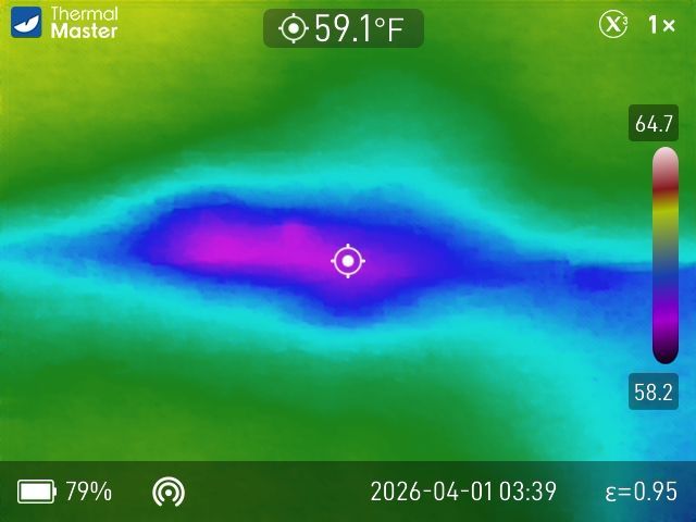 Thermal imaging display showing a cool purple-blue center spot measuring 59.1°F against a warmer green background.