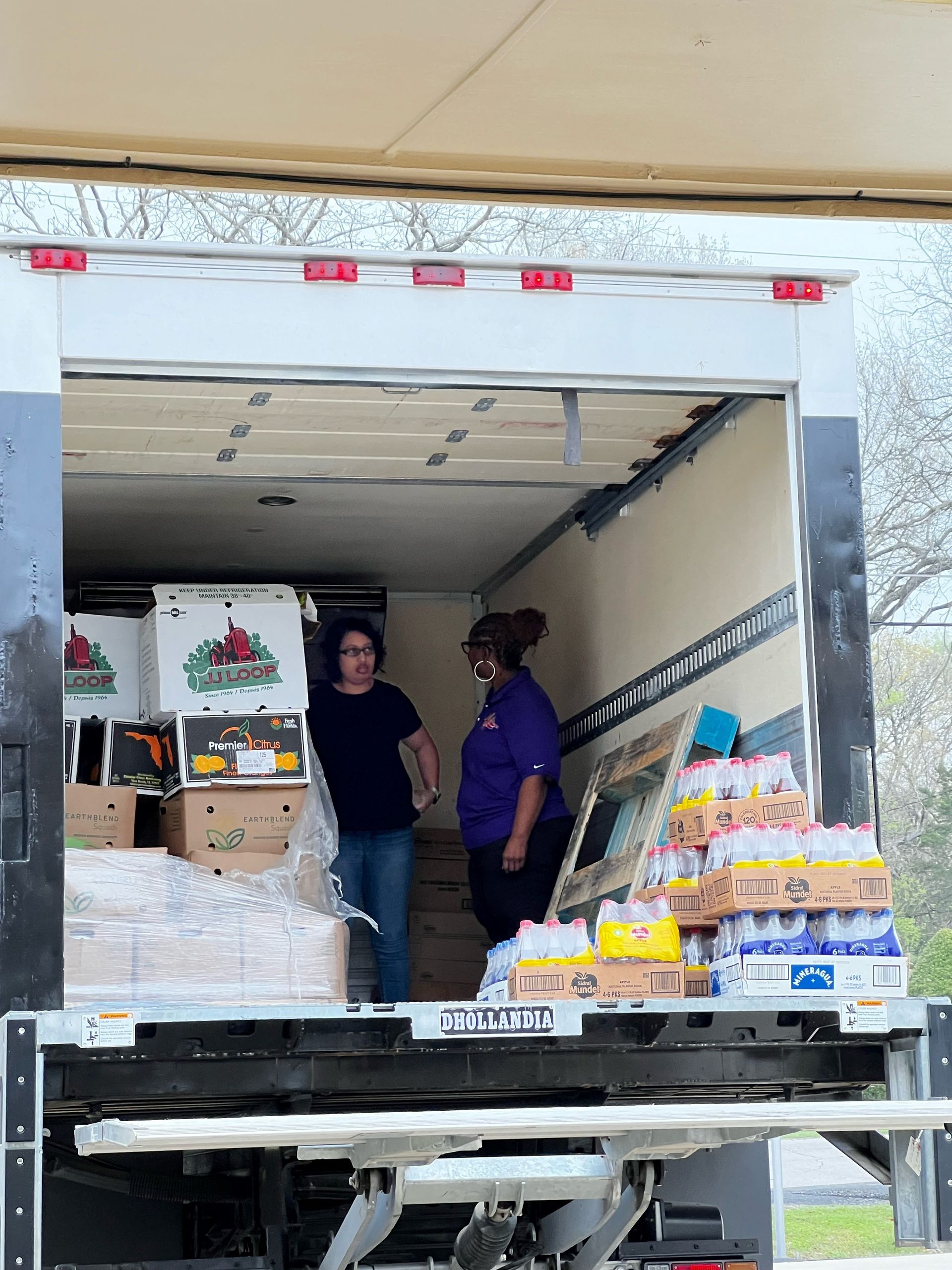 A couple of people are standing in the back of a truck. - Lancaster, TX - International Harvest Fellowship Ministries