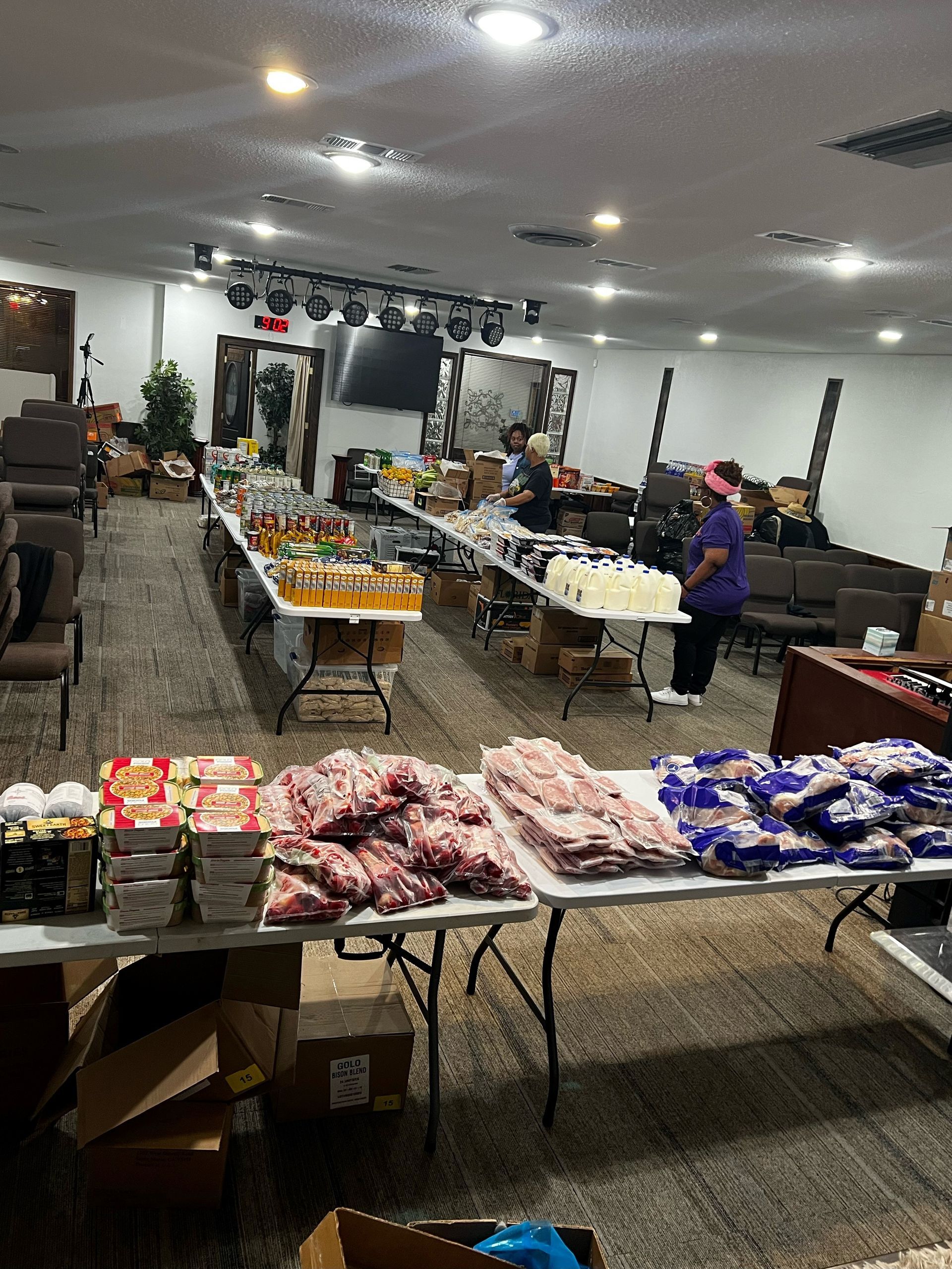A large room filled with tables and boxes of food. - Lancaster, TX - International Harvest Fellowship Ministries
