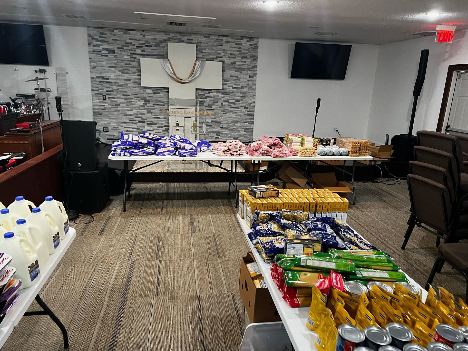 A room filled with tables and boxes of food. - Lancaster, TX - International Harvest Fellowship Ministries