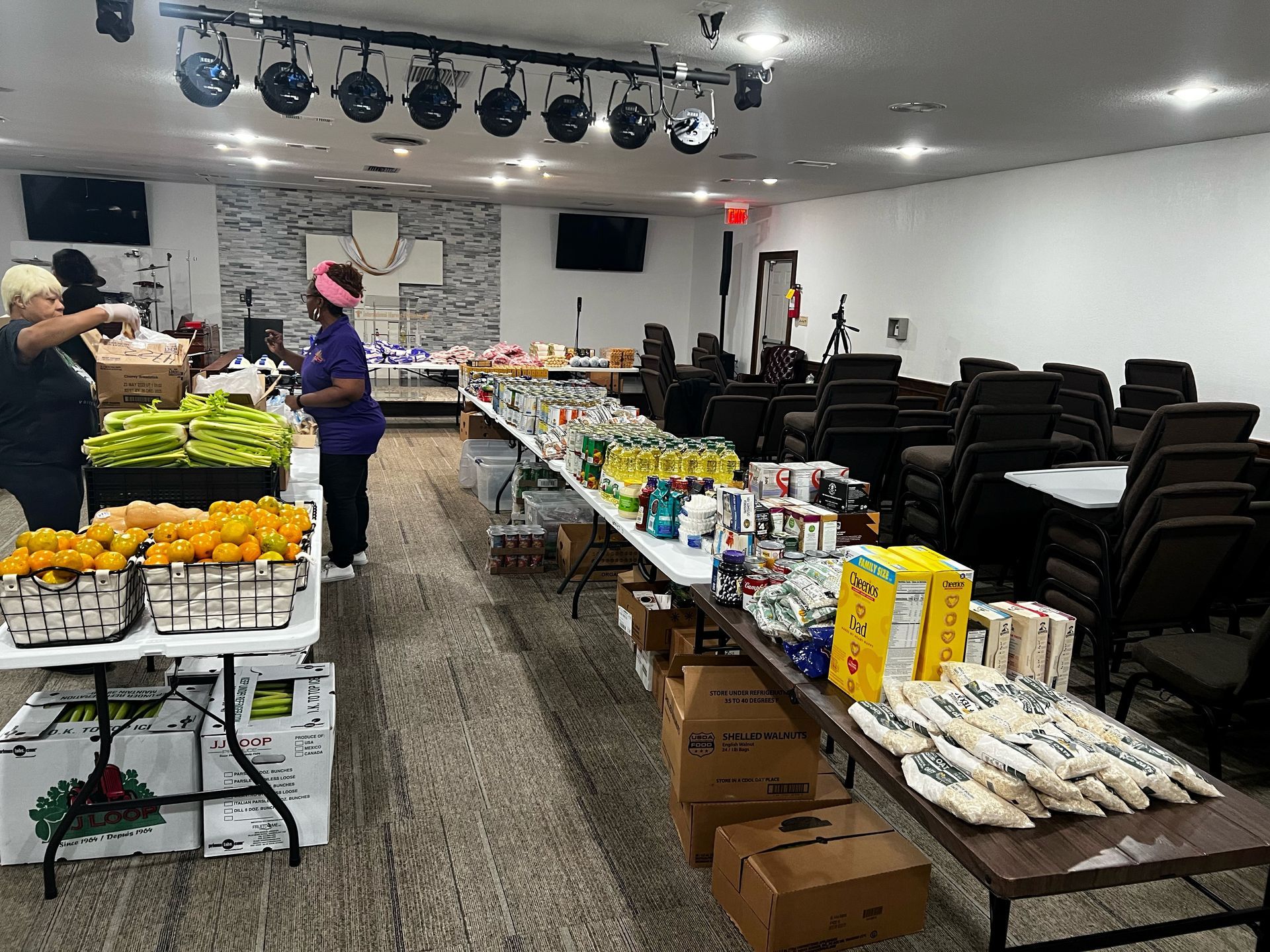 A large room filled with tables and boxes of food. - Lancaster, TX - International Harvest Fellowship Ministries