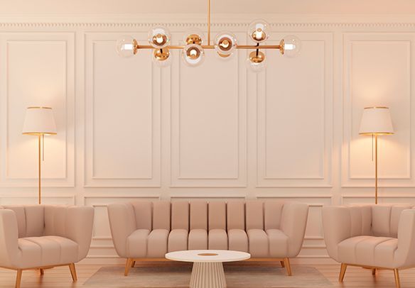 Elegant living room with beige sofa, armchairs, coffee table, lamps, and chandelier against paneled walls.