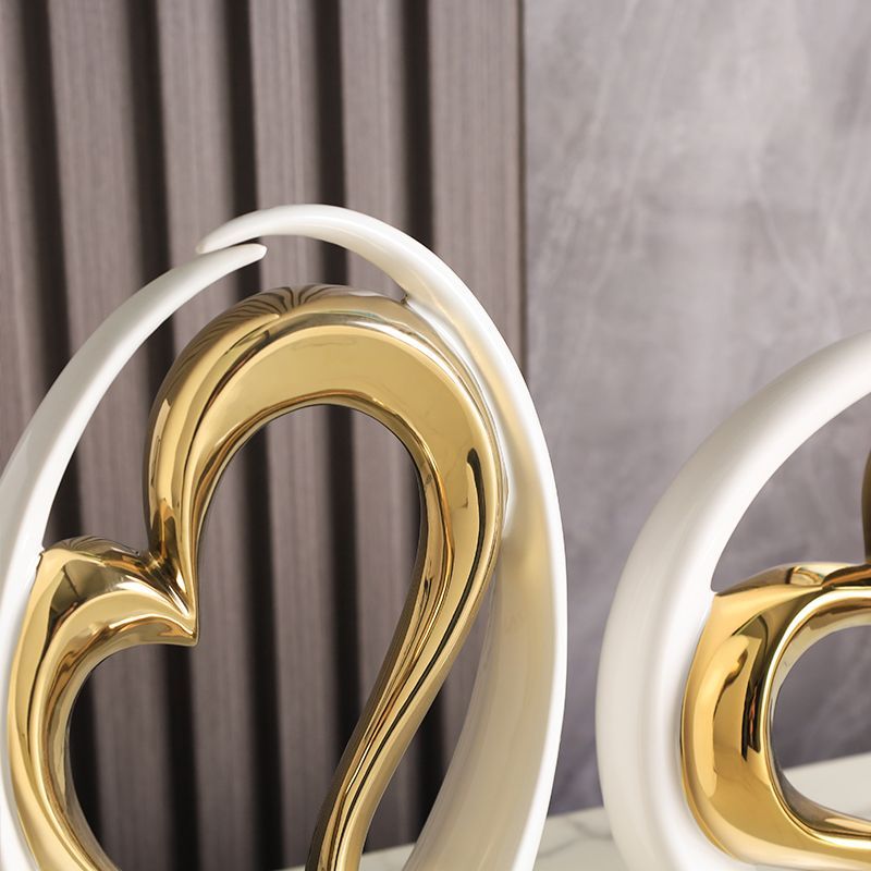 Gold heart-shaped decor with white metal framing against a gray background