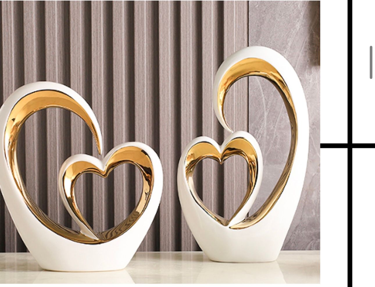White and gold heart-shaped tabletop sculpture on a shelf with measurement labels