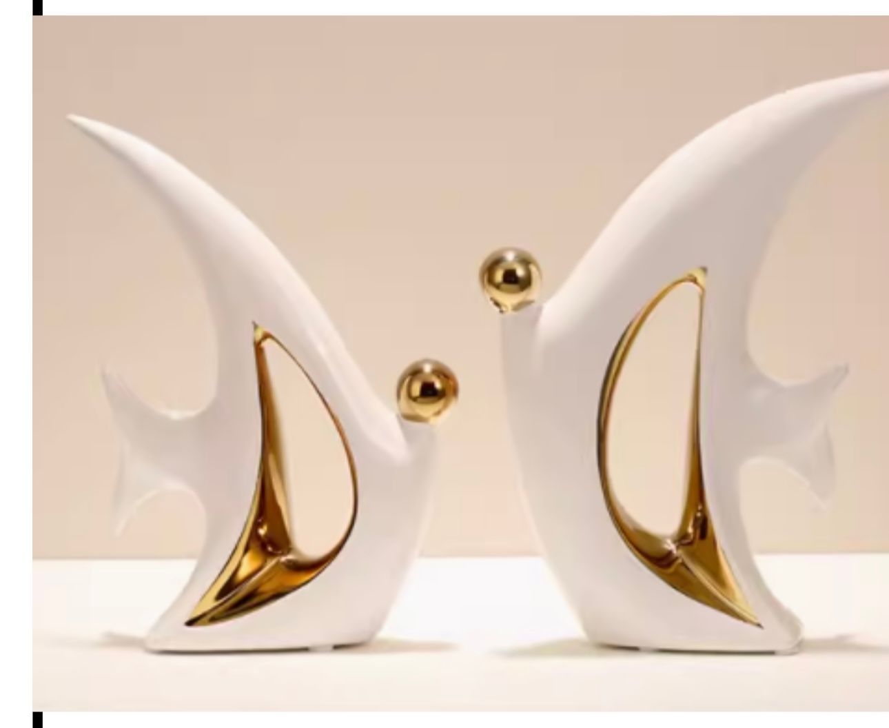 Abstract white and gold modern sculptures with two gold spheres on a beige background