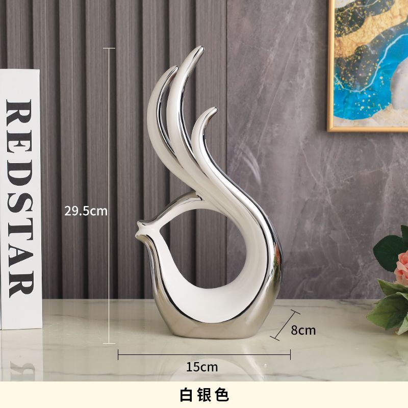 White abstract flame-shaped decorative sculpture on a tabletop, with gold base and height/size measurements shown.