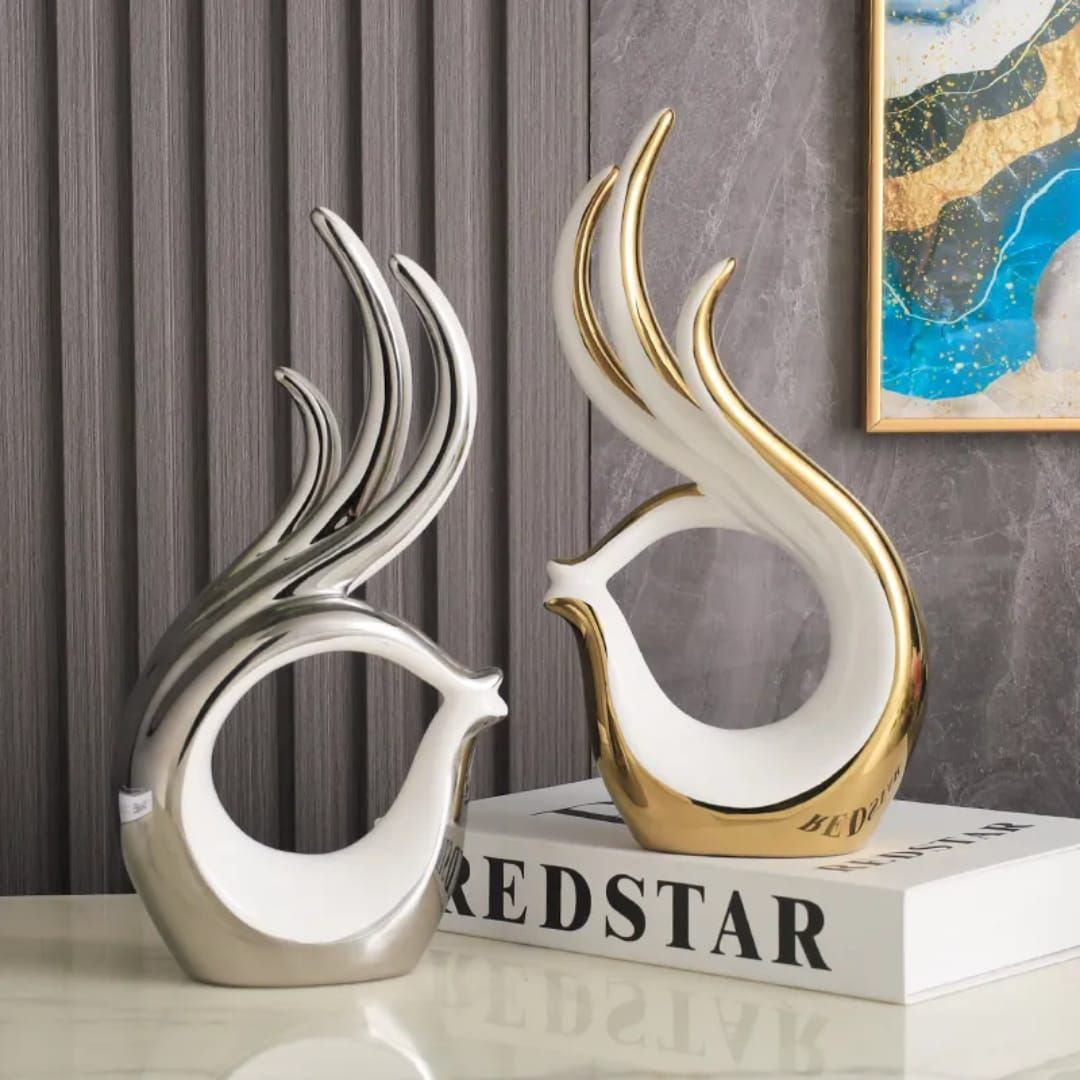 White abstract flame-shaped decorative sculpture on a tabletop, with gold base and height/size measurements shown.