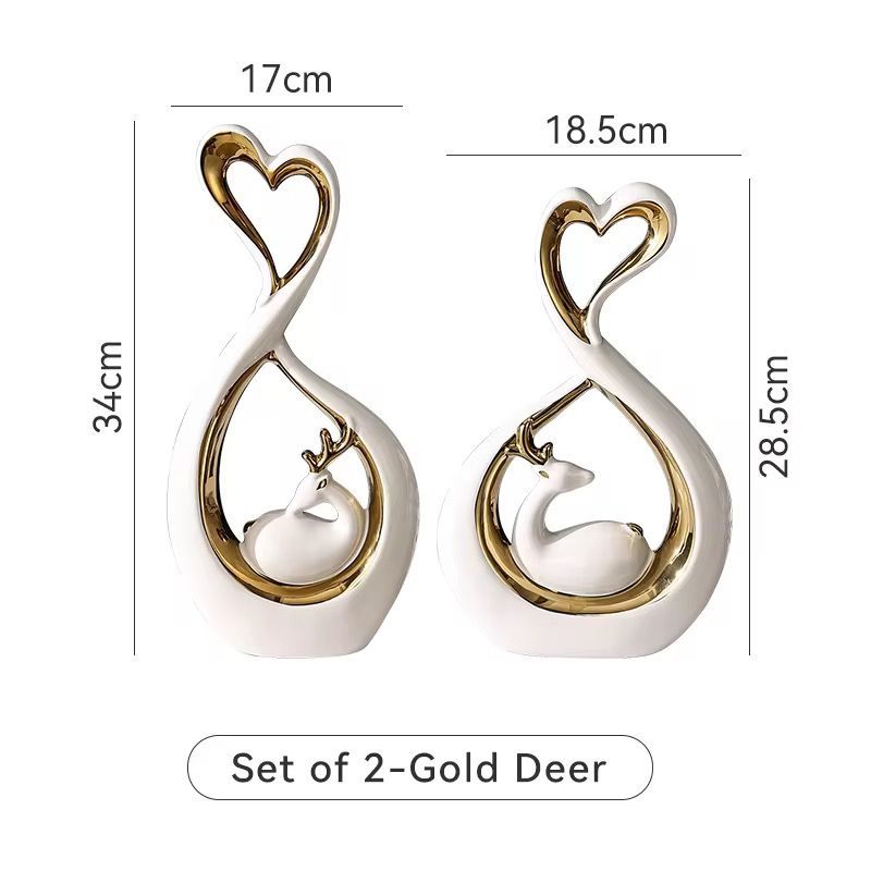 Set of two gold deer-shaped decorative figurines with heart tops, shown with size measurements.