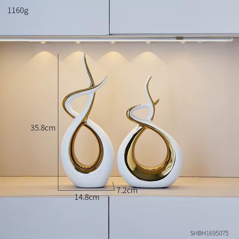 Abstract gold and white sculptural vase with looping curved design