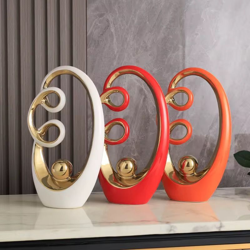 White and gold abstract tabletop sculpture with circular cutouts, shown with size labels on a gray background