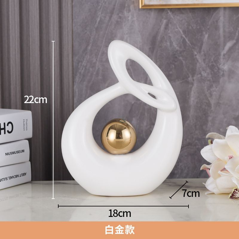 White abstract tabletop sculpture with gold sphere, shown with 22 cm, 18 cm, and 7 cm dimensions.