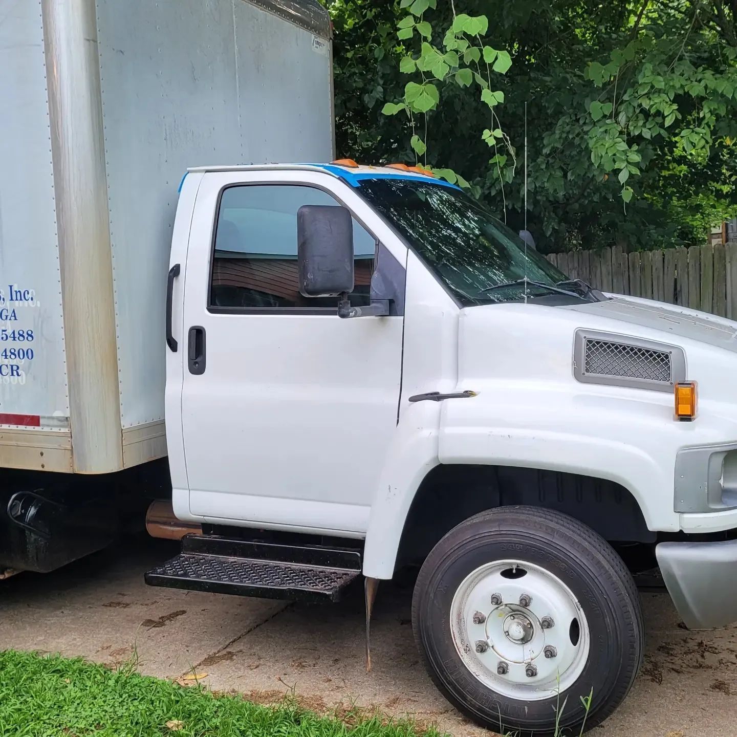 White box truck parked outdoors.