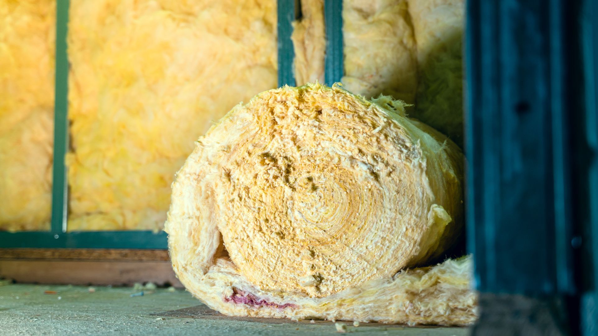 Rolled insulation material inside a wooden frame, yellow color. Rolled insulation material inside a wooden frame, yellow color.
