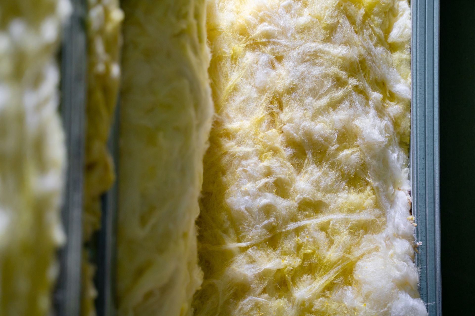 Yellow insulation material inside metal studs. Yellow insulation material inside metal studs.
