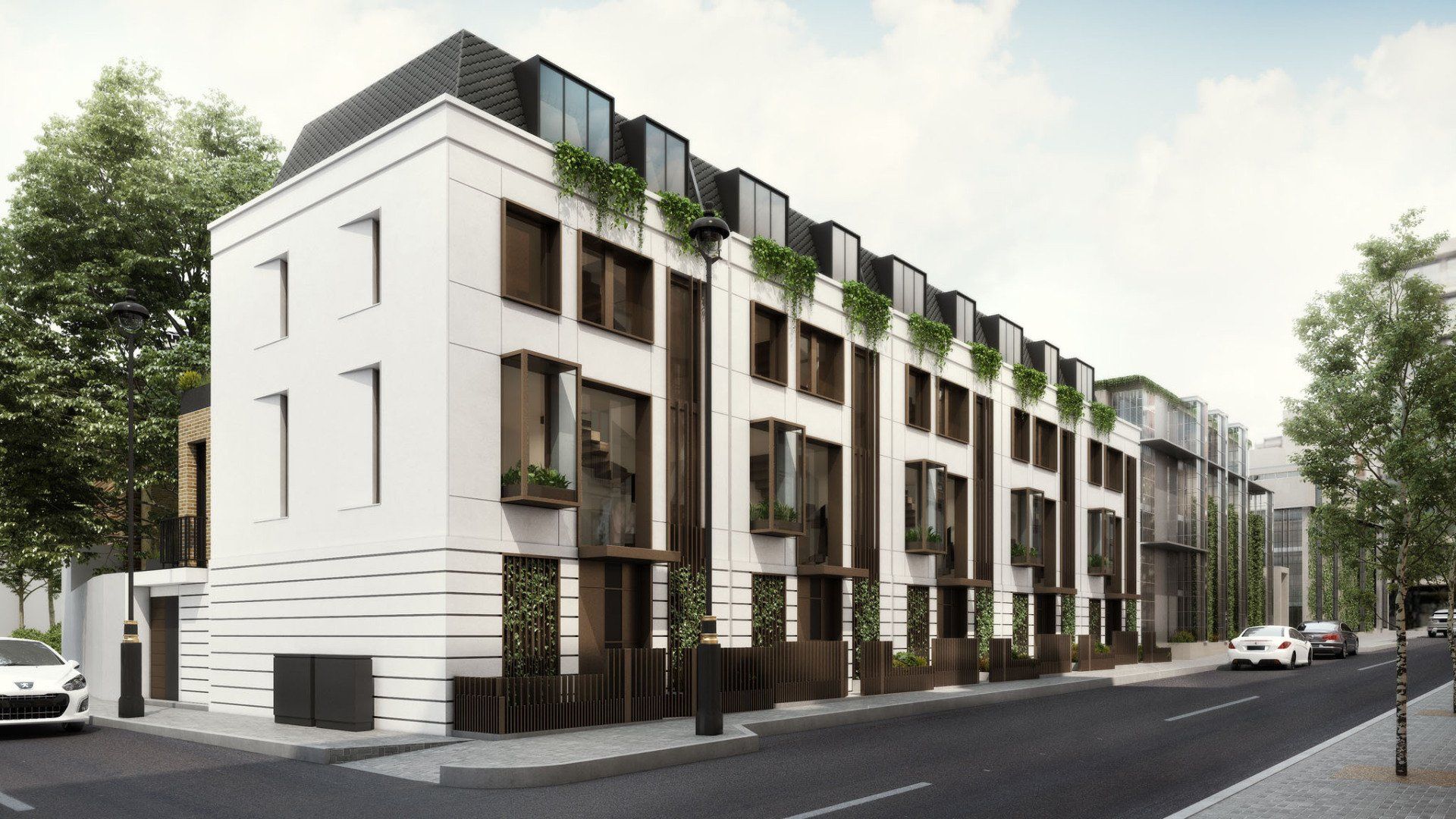 Modern white apartment building with balconies on a tree-lined street