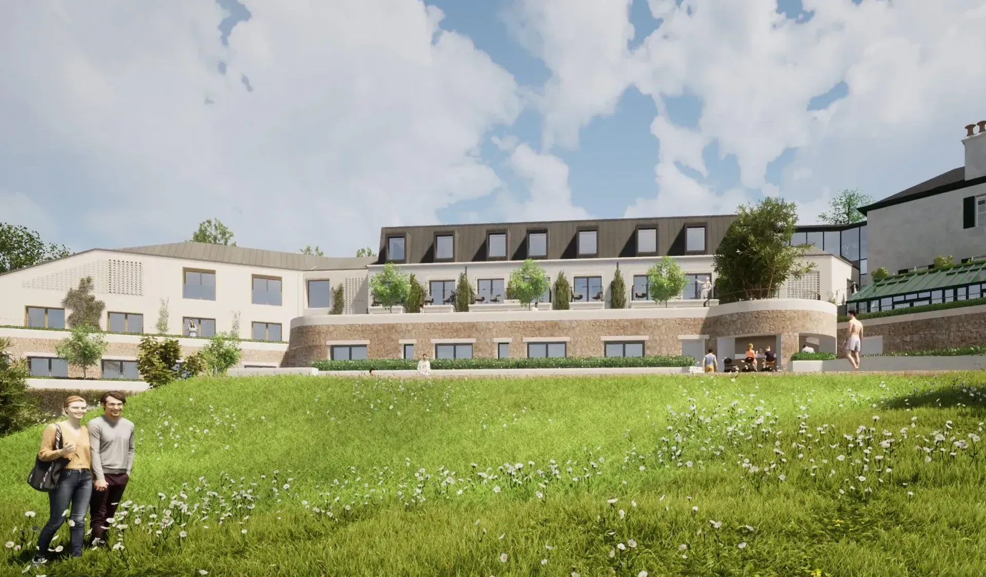 Modern apartment complex with a grassy lawn, terrace seating, and two people walking in front