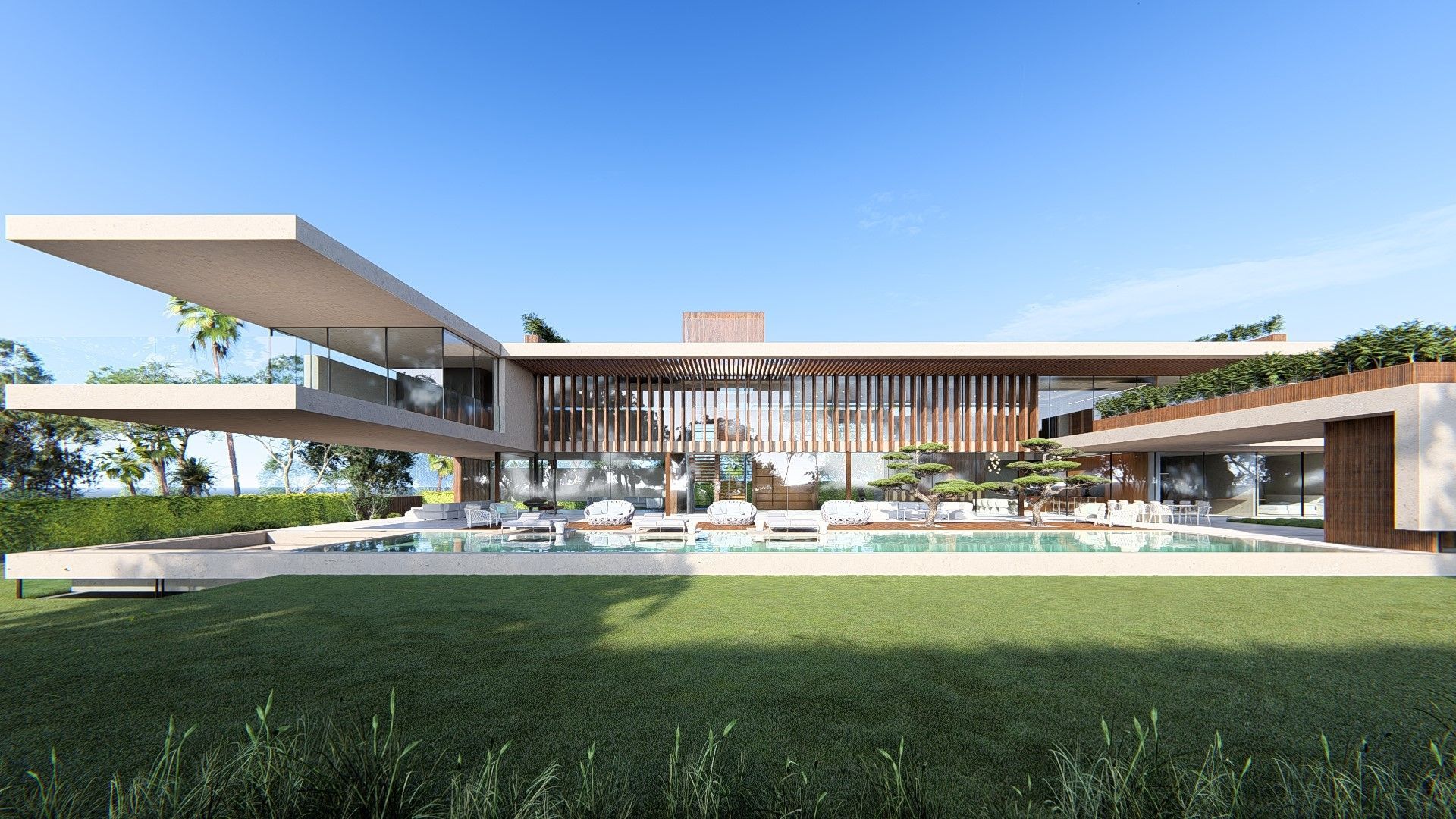 Modern glass house with wide overhanging roof, open patio, and green lawn under a blue sky