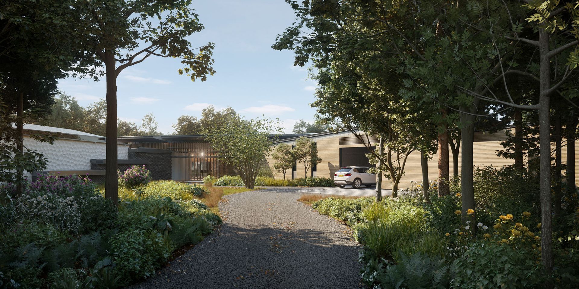 Tree-lined gravel path leading to houses in a sunny garden courtyard