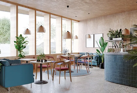 Bright modern café interior with wooden tables, teal chairs, hanging lamps, and large windows