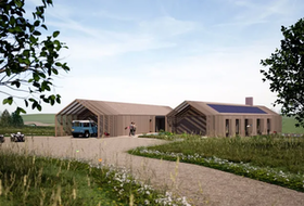 Modern wooden house with sloped roofs, a gravel driveway, and a blue van in a rural field