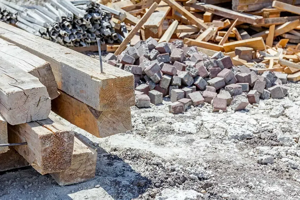 A pile of wood and bricks on a construction site.