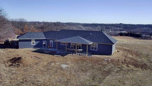 An aerial view of a house under construction in a field.
