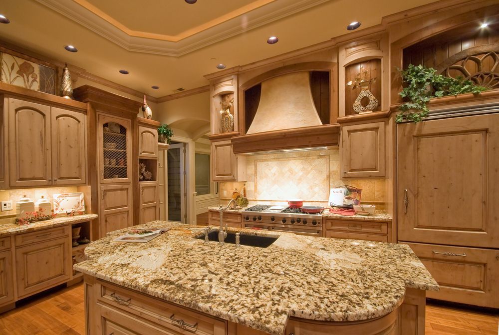 A large kitchen with dark brown wooden cabinets and matching walls