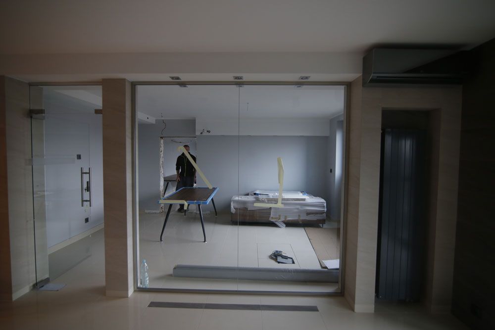 A large, empty room in the middle of a paint job