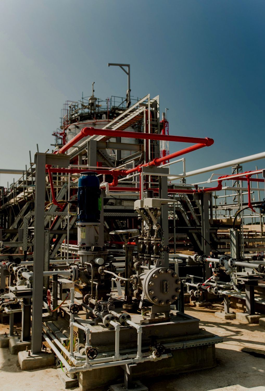 A large industrial plant with lots of pipes and machinery